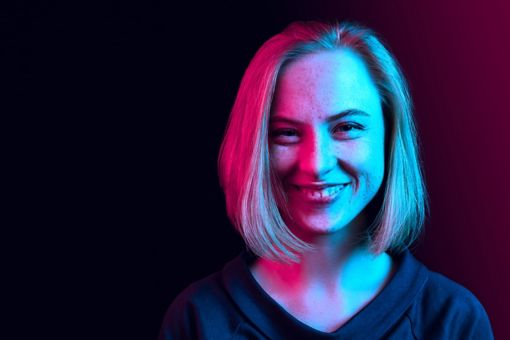 Brightly lit woman smiles at the camera