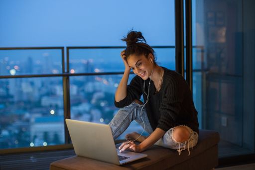 Girl sitting using her laptop
