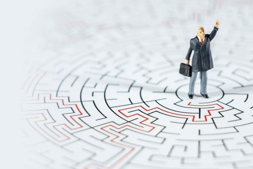 Miniature businessman in centre of maze