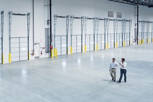 Men walking in warehouse