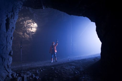 Surveyer with open cut mine in the background