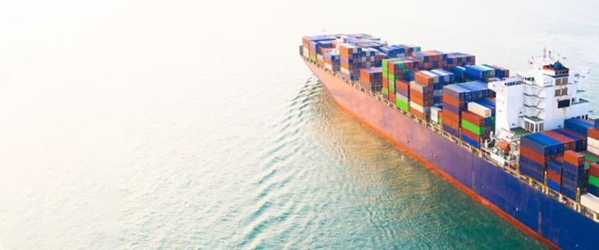 Aerial side view container ship carrying container in import export business logistic and transportation.