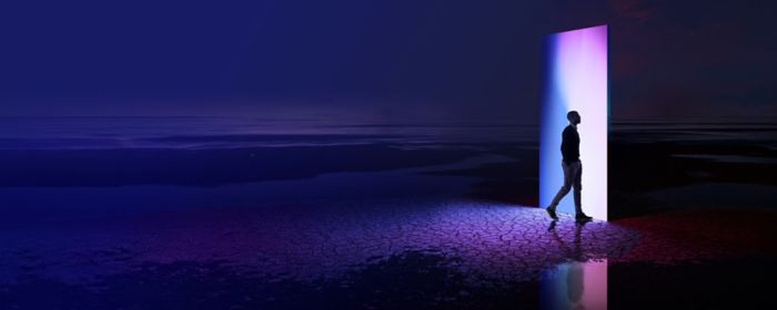 Man walking through a multi-coloured portal