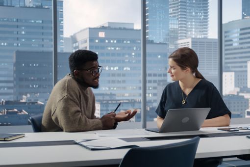Two coworkers having discussion in office