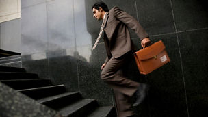 Executive running up the stairs 