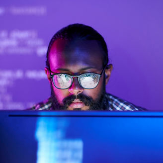 Man with specs working on computer