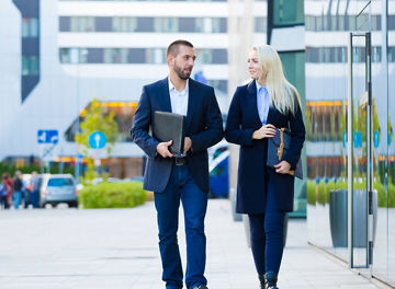 People walking outside next to a building