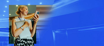 Person smiling whilst using a mobile phone